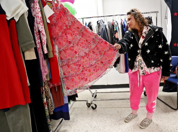 Angie picks out a pretty pink dress as homeless women get a makeover courtesy of Macy's at Saint Anthony Shrine in Boston Staff Photo by Nancy Lane/Boston Herald (Tuesday,June 13, 2023). on the Boston Common on Tuesday, in Boston, MA. (Nancy Lane/Boston Herald) June 13, 2023