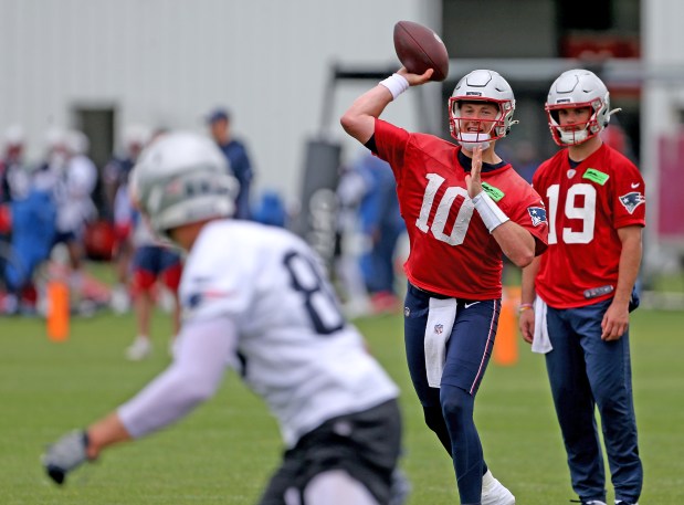 Mac Jones #10 of the New England Patriots throws a pass as Trace McSorley looks on during mini camp at Gillette Stadium on Tuesday in Foxboro, MA. (Matt Stone/Boston Herald) June 13, 2023